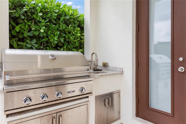 view of patio / terrace with grilling area and sink