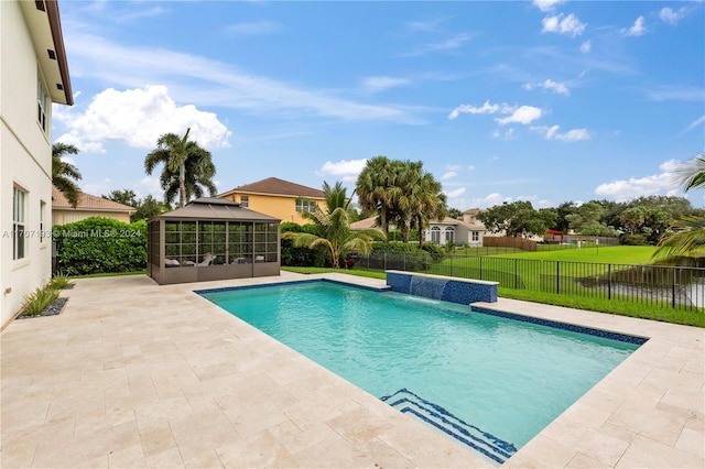 view of swimming pool featuring pool water feature, a yard, and a patio