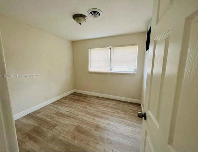 unfurnished room featuring light hardwood / wood-style floors