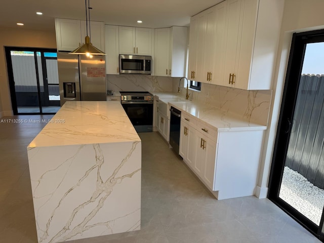 kitchen with decorative light fixtures, a kitchen island, stainless steel appliances, and tasteful backsplash