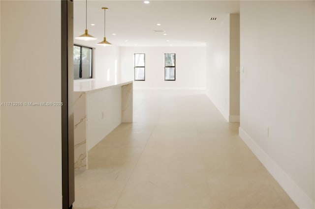 hall featuring light tile patterned flooring