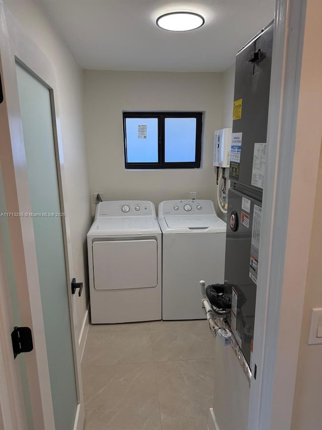 laundry room featuring separate washer and dryer and light tile patterned floors