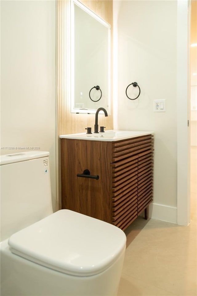 bathroom with vanity and toilet