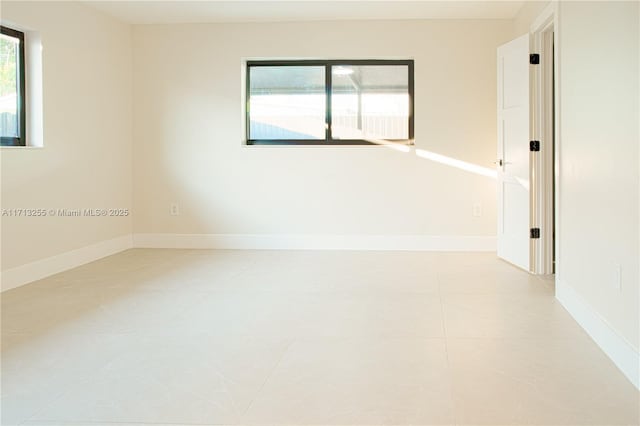 unfurnished room with light tile patterned floors