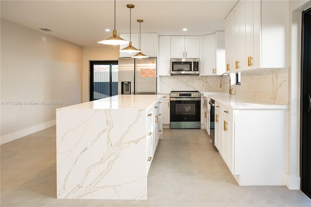 kitchen with a center island, sink, stainless steel appliances, pendant lighting, and white cabinets