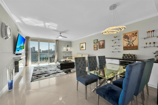 tiled dining space featuring ceiling fan with notable chandelier, a wall of windows, and crown molding