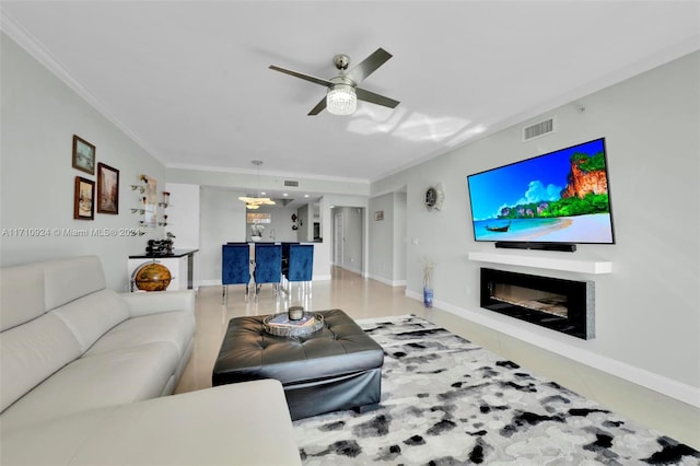 living room with ceiling fan and crown molding