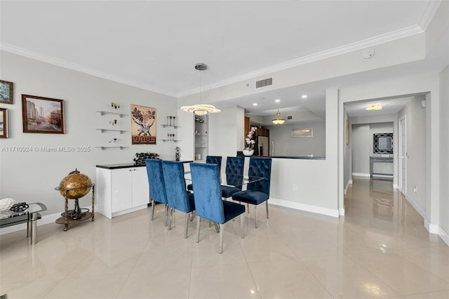 dining room featuring crown molding and light tile patterned floors