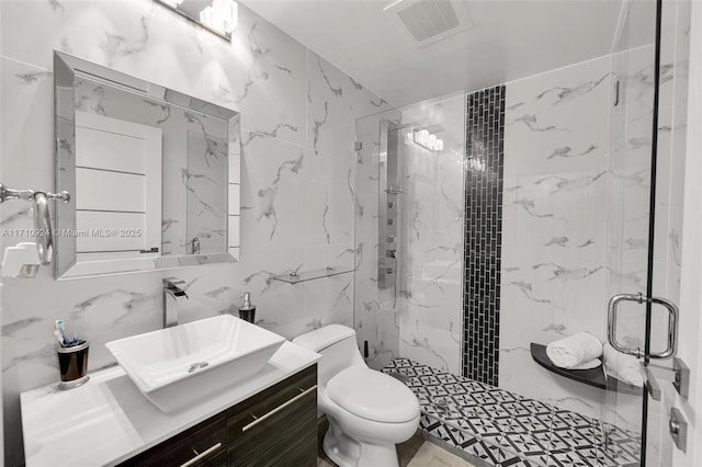 bathroom featuring a shower with shower door, tile walls, toilet, and vanity