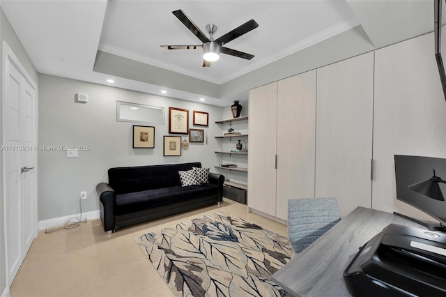 living room with ceiling fan, a raised ceiling, ornamental molding, and light tile patterned floors