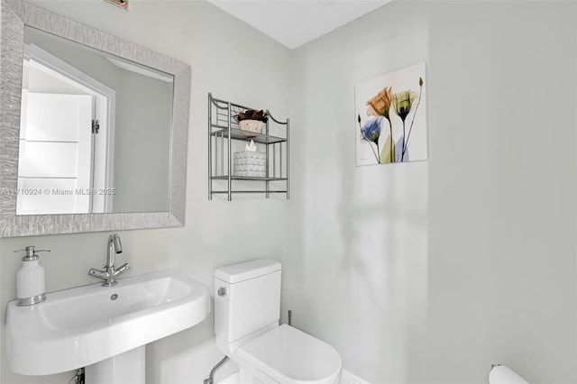 bathroom featuring sink and toilet