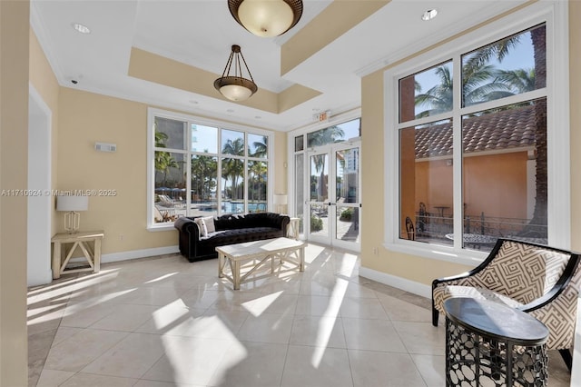 sunroom / solarium with a raised ceiling, french doors, and a healthy amount of sunlight