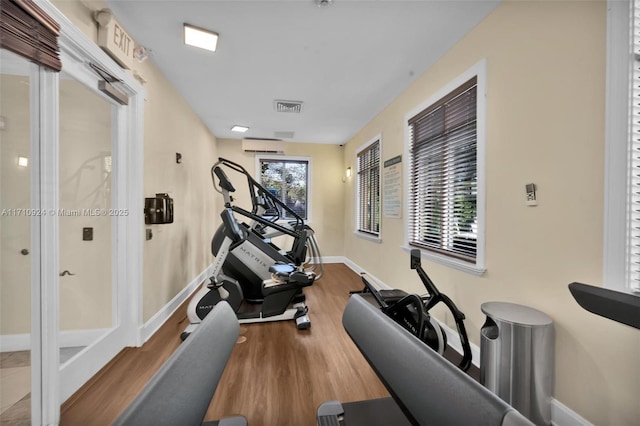 exercise area featuring light hardwood / wood-style floors