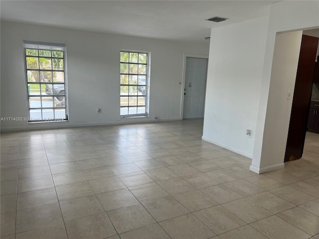 unfurnished room with light tile patterned floors