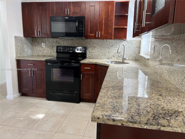 kitchen featuring backsplash, black appliances, sink, light stone countertops, and light tile patterned floors