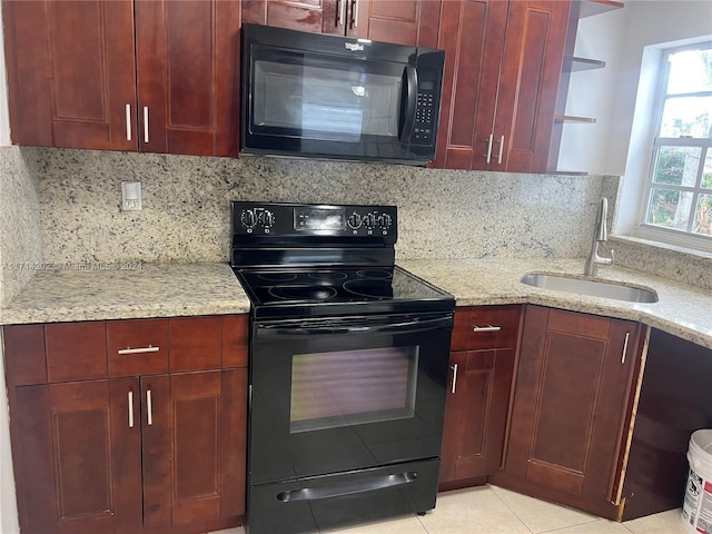 kitchen with sink, light stone counters, decorative backsplash, light tile patterned floors, and black appliances