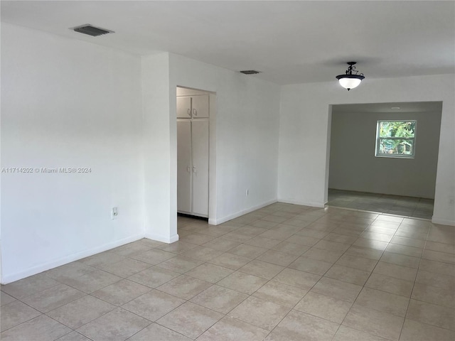 spare room with light tile patterned floors