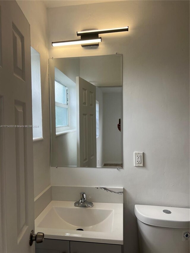 bathroom featuring vanity and toilet