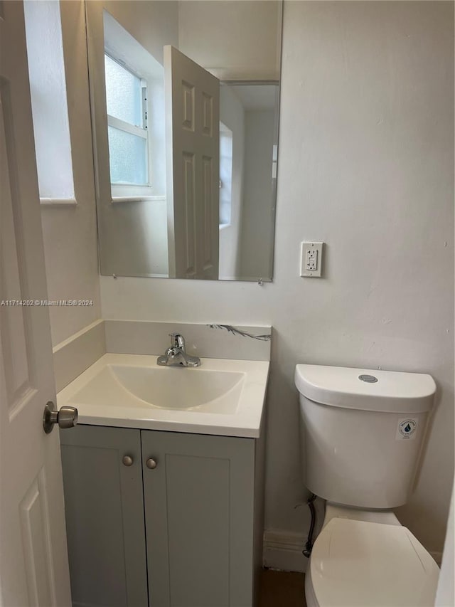 bathroom featuring vanity and toilet