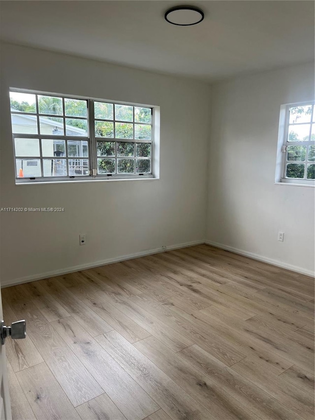 unfurnished room with light hardwood / wood-style floors