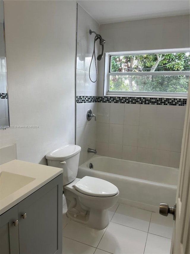 full bathroom featuring tile patterned floors, toilet, vanity, and tiled shower / bath