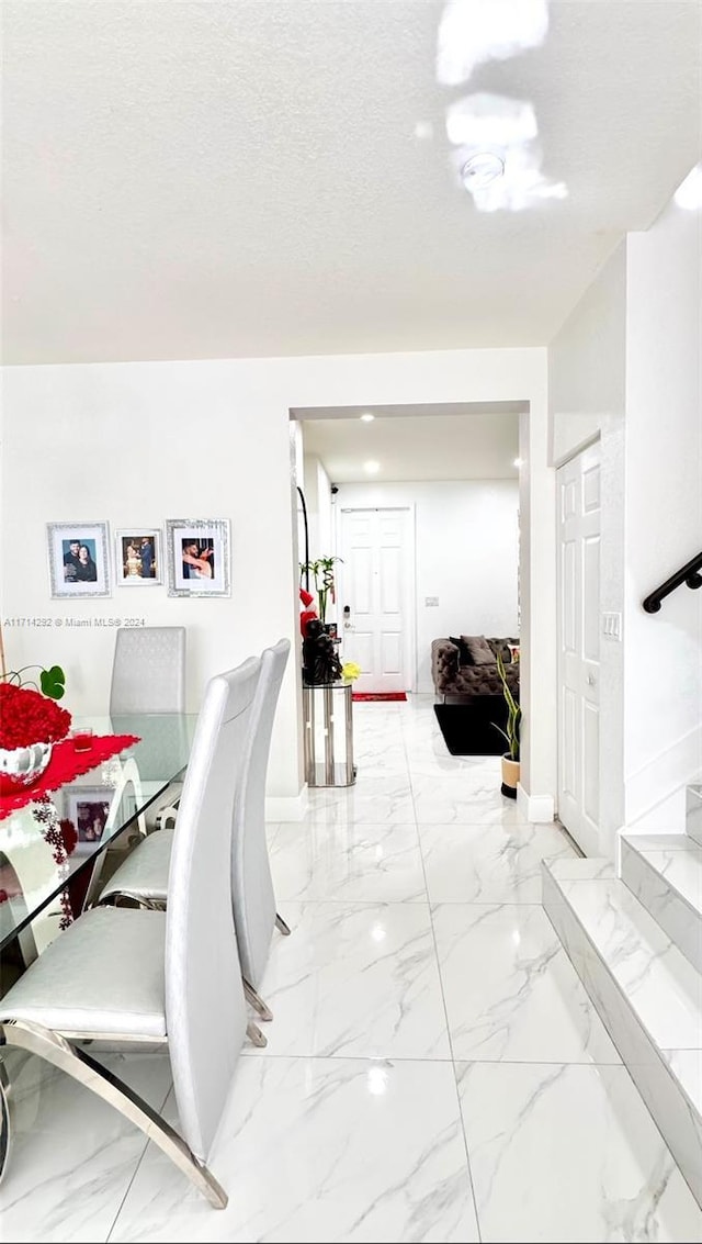 dining space with a textured ceiling