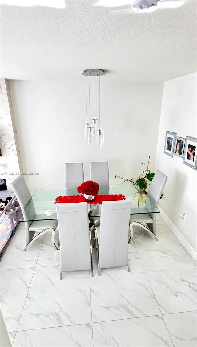 dining space with a textured ceiling