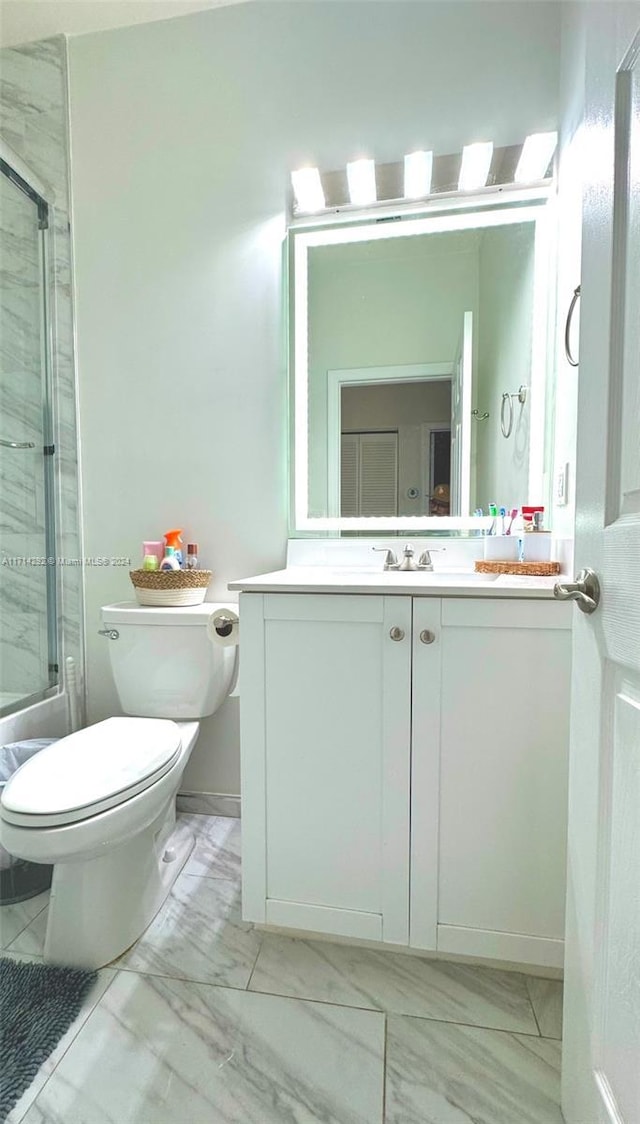 full bathroom with vanity, toilet, and combined bath / shower with glass door