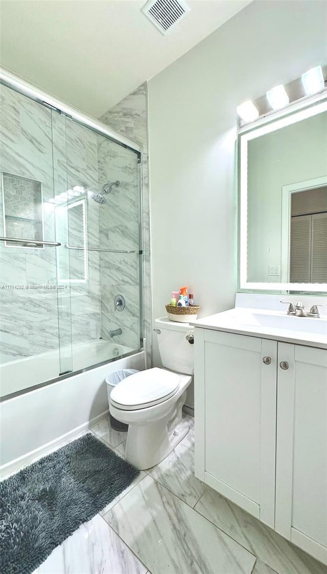 full bathroom with vanity, toilet, and shower / bath combination with glass door