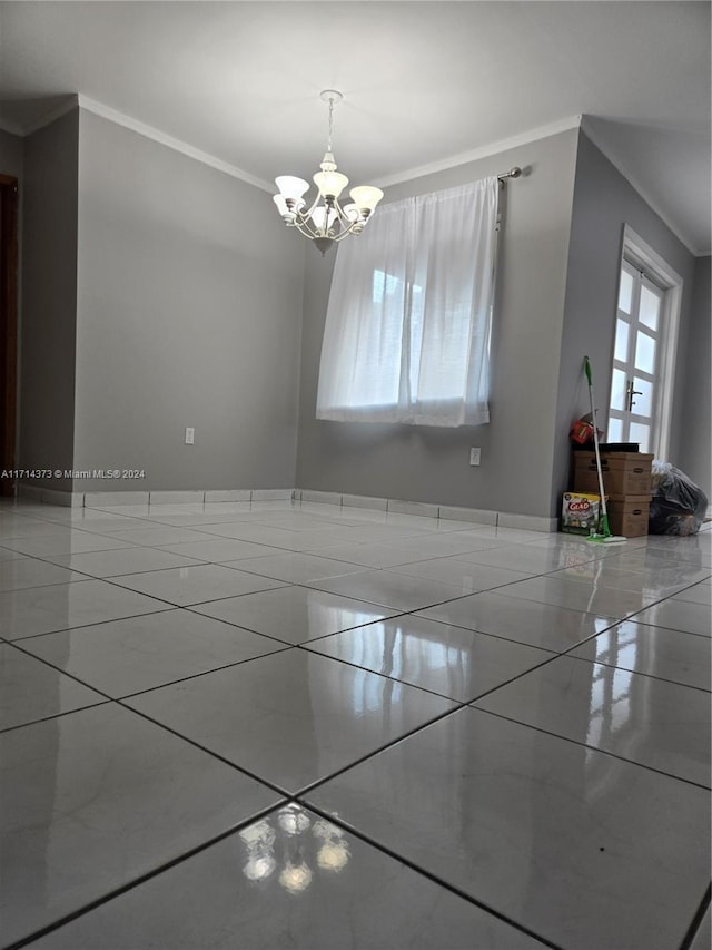 empty room featuring ornamental molding and a chandelier