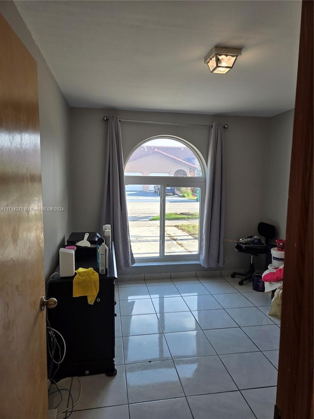 doorway to outside with light tile patterned floors