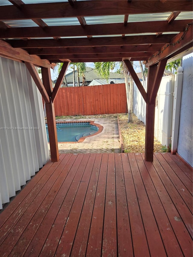 wooden terrace with a fenced in pool