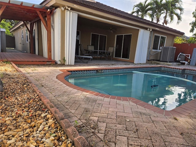 view of swimming pool with a patio, a deck, and central AC unit