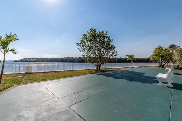 view of sport court with a water view