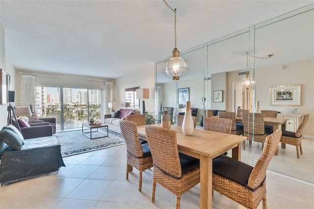 tiled dining space featuring an inviting chandelier