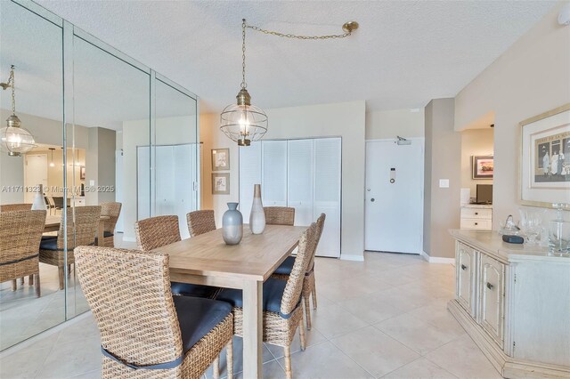 500 Bayview Dr Unit 617, Sunny Isles Beach, FL 33160 - dining space with light tile patterned flooring and a textured ceiling