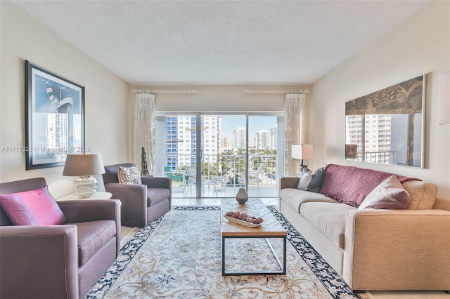 living room with tile patterned floors and a textured ceiling