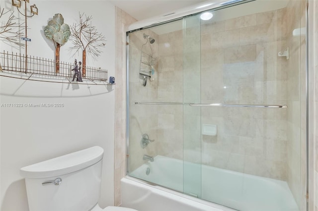 bathroom with enclosed tub / shower combo and toilet