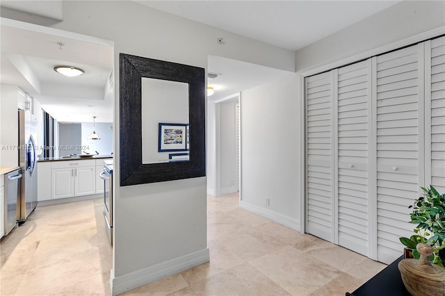 hall featuring light tile patterned floors