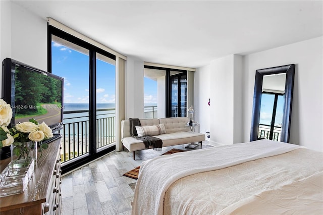 bedroom featuring light hardwood / wood-style flooring and expansive windows