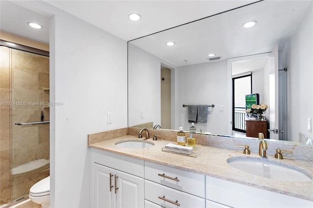 bathroom featuring an enclosed shower, vanity, and toilet