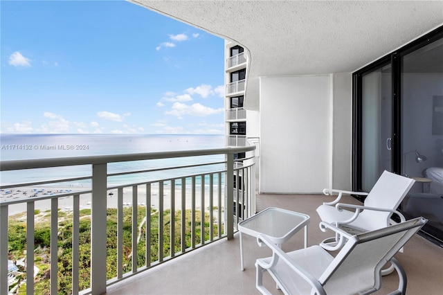 balcony with a view of the beach and a water view