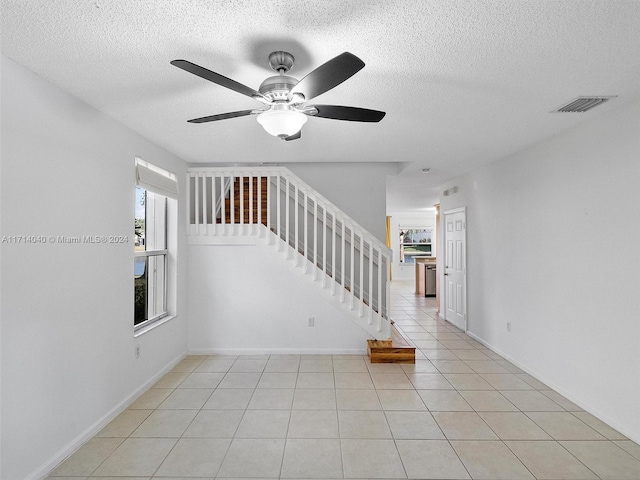 interior space with tile patterned flooring and ceiling fan