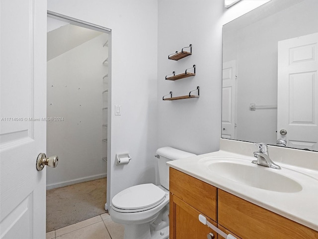 bathroom featuring toilet, vanity, and tile patterned floors