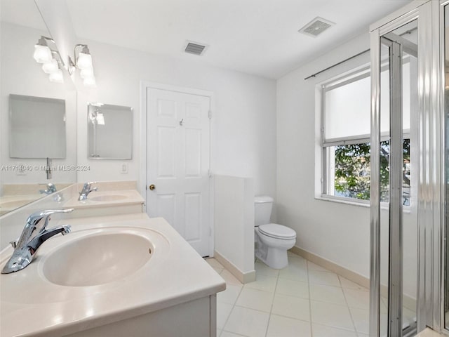 bathroom with tile patterned flooring, vanity, and toilet