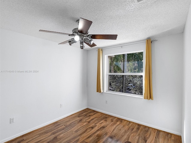 spare room featuring a textured ceiling, hardwood / wood-style flooring, and ceiling fan