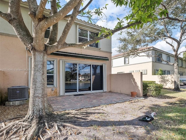 back of house with a patio area and central AC unit