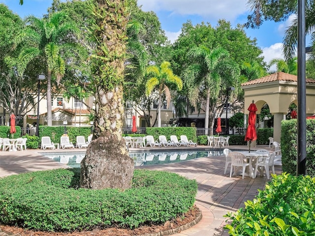 view of home's community featuring a patio area and a pool