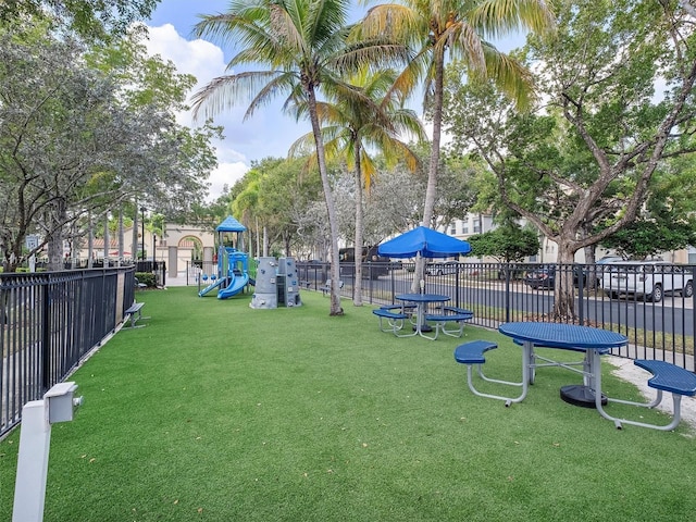 view of home's community with a playground and a yard