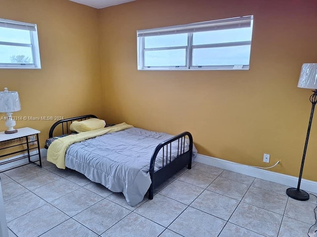 bedroom featuring light tile patterned floors